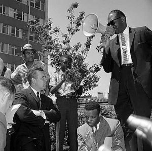 Rev. Mance Jackson (seated in front) as Rev. Samuel McKinley Speaks