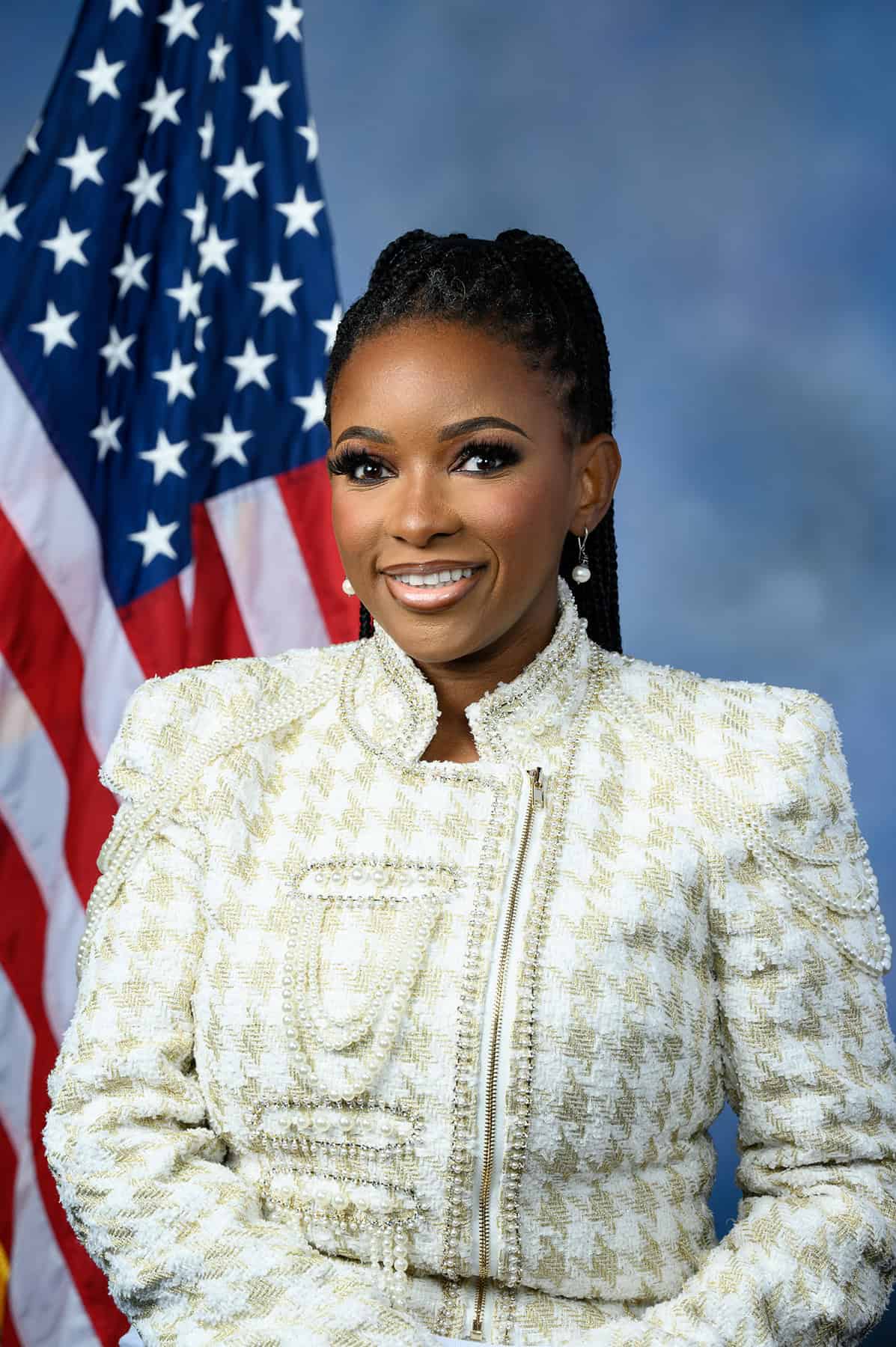 Rep. Jasmine Crockett posing in front of American flag