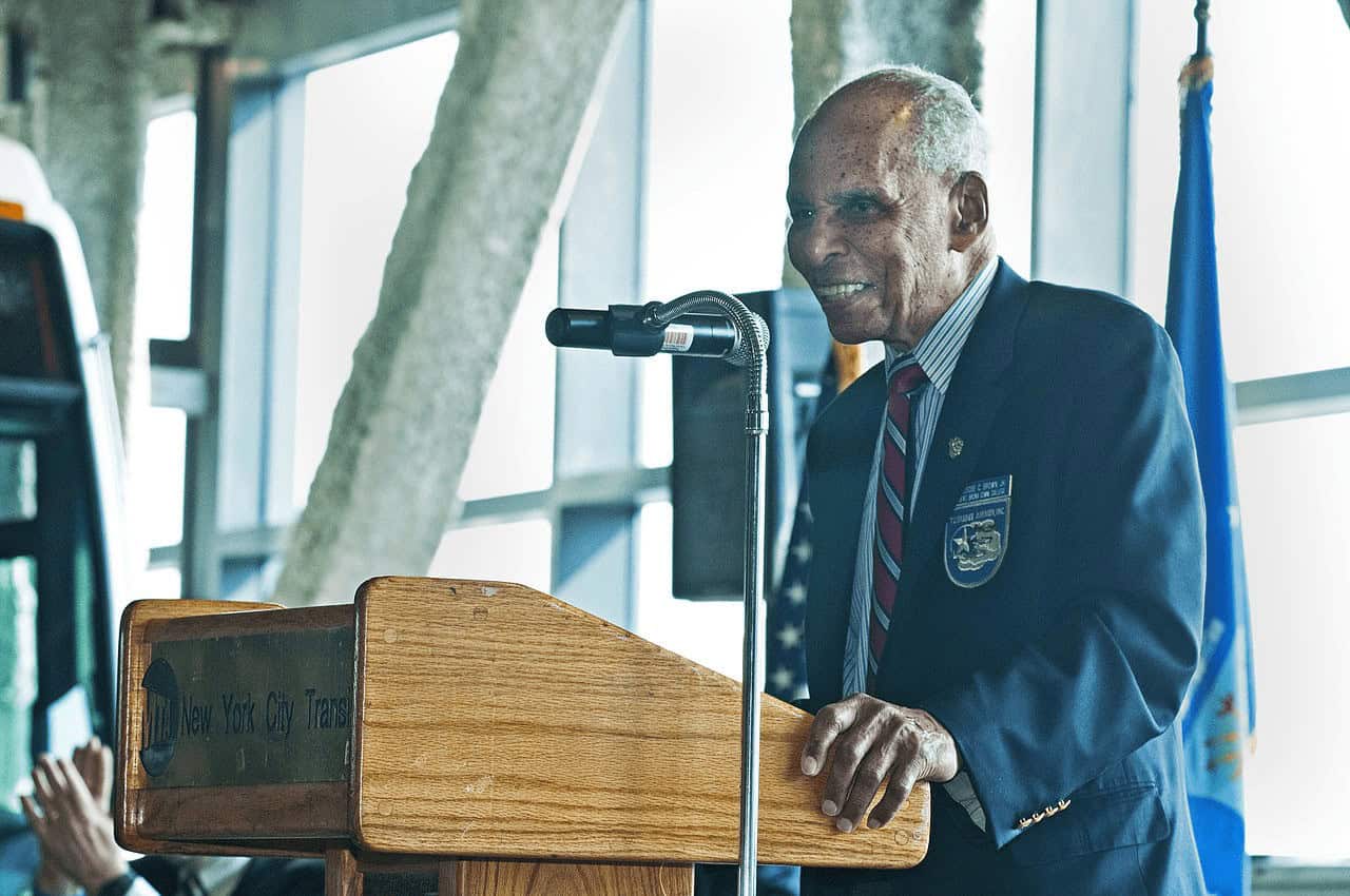 Tuskegee Airman Roscoe C. Brown Jr. delivering remarks at the 2012 Tuskegee Airmen Bus Depot ceremony|Mechanic Marcellus Smith and Pilot Roscoe C. Brown Working on P-51 Mustang (Courtesy of Alamy Images).